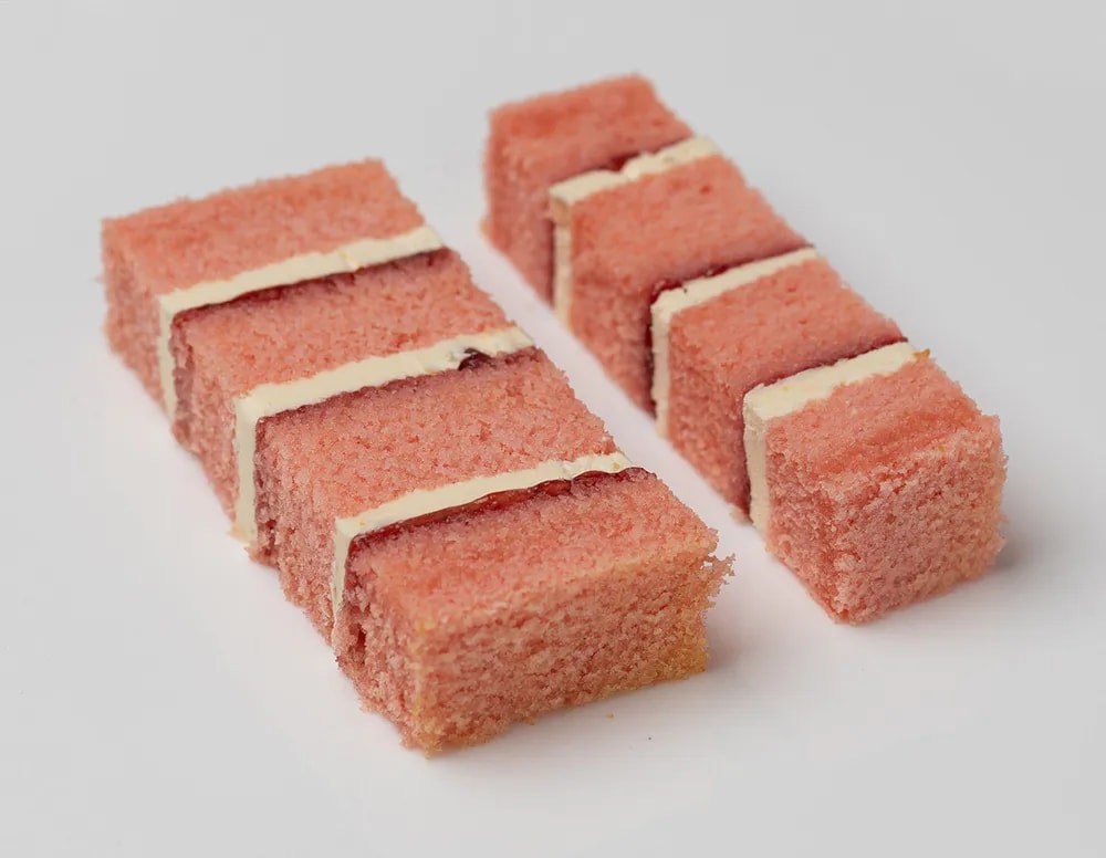 Pink champagne sponge, filled with alternating layers of champagne buttercream and strawberry preserve.